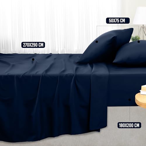 Vierdelige Utopia Bedding Beddelakenset in de kleur marineblauw netjes uitgestald op een tweepersoonsbed